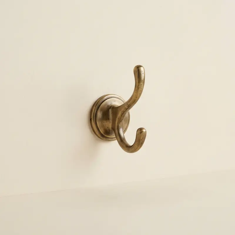 Calder brass towel hook in Aged brass