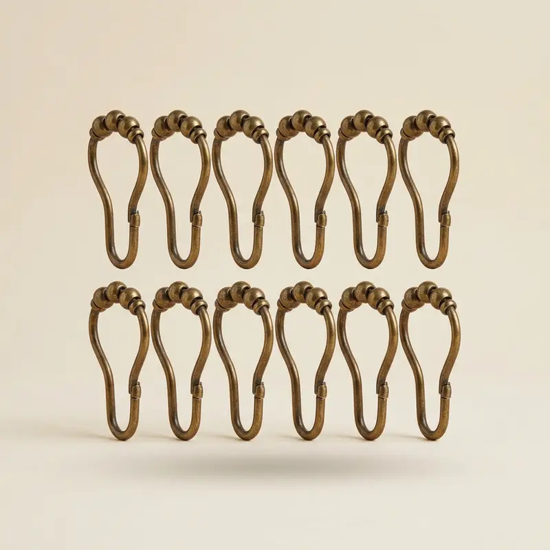 Calder shower curtain hooks, set of 12 in Aged brass